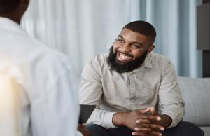 Man with a bread enjoying his therapy session smiling.