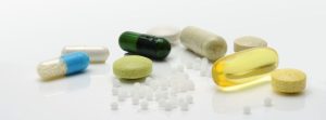 Variety of pills & pellet's on a table.