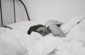Sleeping Woman in bed with covers on.
