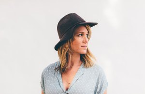 woman in blue shirt with black hat