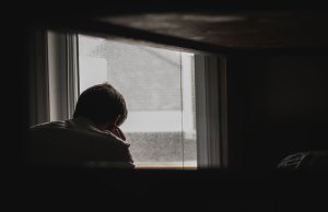 Man in front of window.