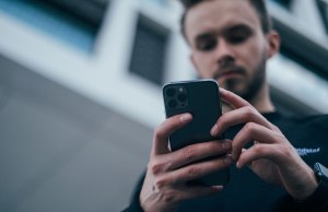Man texting on his smartphone.