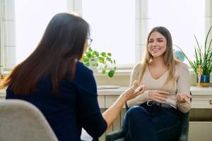 Woman smiling while talking to a therapist