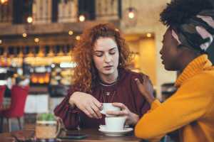 Two women talking at a coffee shop